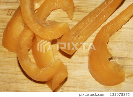 Close up of chopped sliced sweet pepper on a wooden chopping board 133978875