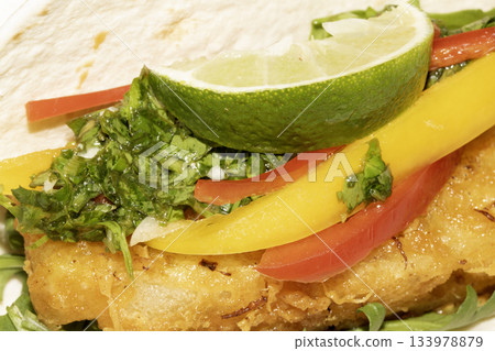 A very tasty fried pineapple taco with peppers and lime street food fresh meal A very tasty fried pineapple taco with peppers and lime street food fresh meal 133978879