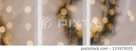 Banner white wooden window frame with blurred warm lights in festive indoor setting 133979205