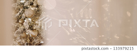 Banner soft beige holiday background with silver garland and ornaments Banner soft beige holiday background with silver garland and ornaments 133979215