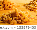 Texture of dry fusilli pasta. Italian cuisine 133979403
