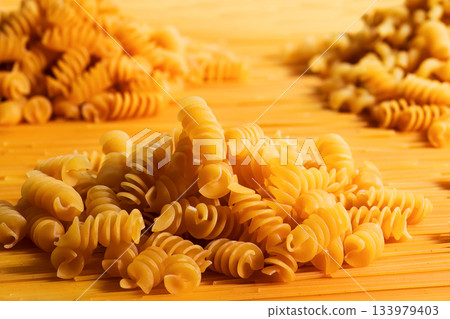 Texture of dry fusilli pasta. Italian cuisine 133979403