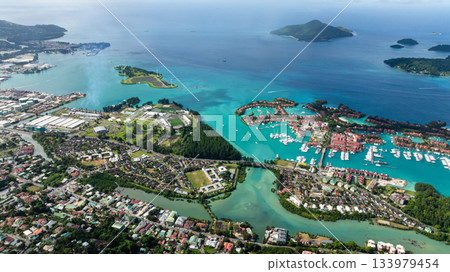 Aerial view of Eden Island with numerous yachts, clear turquoise waters, green landscapes. Seychelles, Mahe. 133979454