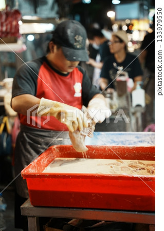 A bustling Taiwanese night market. A scene of street food stalls filled with excitement 133979550