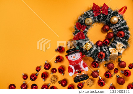 Festive setup of a snowman figurine, Christmas wreath Festive setup of a snowman figurine, Christmas wreath 133980331