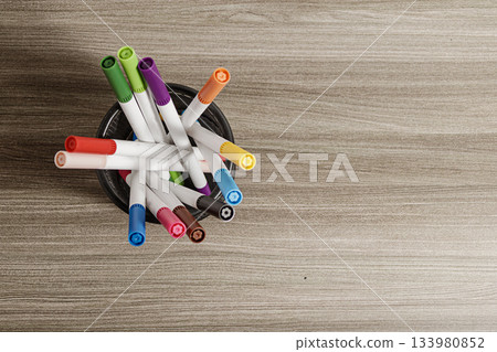 Colorful Markers in a Cup on a Wooden Table. Education and Art Concept, Blank Background. Top View Angle Image. High quality photo 133980852