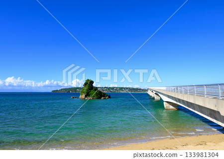 A spectacular view of Kouri Bridge spanning the blue sky and emerald green sea 133981304