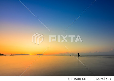 The sunset-colored sea and the beautiful silhouette of Tsunami Godzilla Rock in Ogimi Village The sunset-colored sea and the beautiful silhouette of Tsunami Godzilla Rock in Ogimi Village 133981305