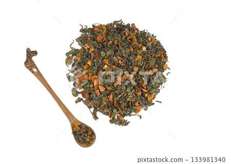 A pile of dry green tea on a white background. Apple flavor. Top view, isolated, close-up. A pile of dry green tea on a white background. Apple flavor. Top view, isolated, close-up. 133981340