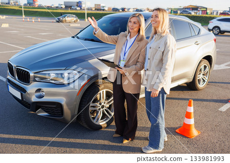 Female Driving Instructor Demonstrating Parking Instructions to Student Female Driving Instructor Demonstrating Parking Instructions to Student 133981993