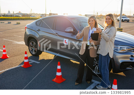 Learner Driver and Instructor Showing Passed Driving License at Test Area Learner Driver and Instructor Showing Passed Driving License at Test Area 133981995