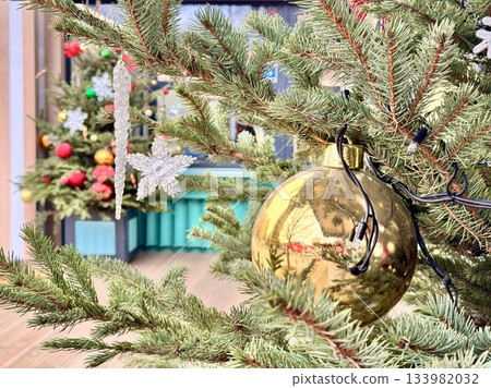 Bright Christmas Tree toys are hanging on the tree. New Year 133982032