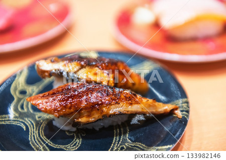 Unagi Eel sushi on black plate in Japanese restaurant 133982146