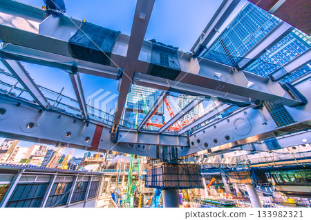 Tokyo cityscape in Japan, December. View of Shibuya's buildings, covered steel frames, crawler cranes, etc. Towards a new era 133982321