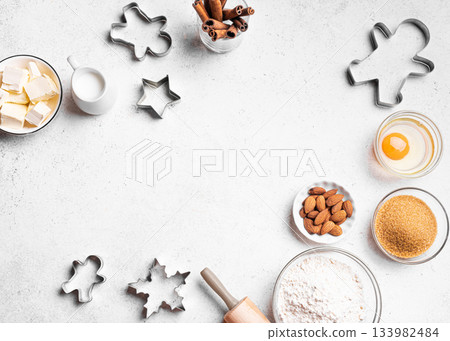 Christmas baking background with baking ingredients and cookie cutters 133982484