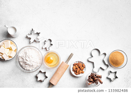Christmas baking background with baking ingredients and cookie cutters Christmas baking background with baking ingredients and cookie cutters 133982486