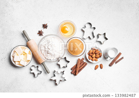 Christmas baking background with baking ingredients and cookie cutters 133982487