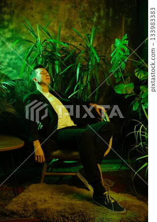 Tranquil moment capturing man lounging amidst lush plants during twilight 133983383