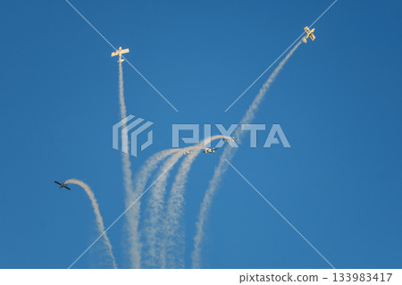 Stunt aerobatic planes performing stunts in air 133983417