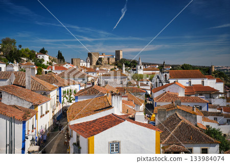 Stunning aerial view of Obidos, a medieval town in Portugal, showcasing its castle, city walls, and charming rooftops. Portugal 133984074