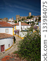 Charming town of Obidos with its medieval castle, ancient city walls, and picturesque rooftops. Portugal 133984075