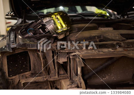 Careful precision is essential when installing a car headlight assembly for optimal performance 133984080