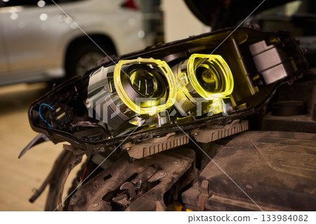 Careful precision is essential when installing a car headlight assembly for optimal performance Careful precision is essential when installing a car headlight assembly for optimal performance 133984082