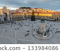 The scenic Praca do Comercio in Lisbon showcases a Christmas tree against the sunset sky, highlighting festive winter charm in the evening. Lisbon, Portugal 133984086