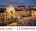 Experience the magic of Christmas in Lisbon as Praca do Comercio glows with festive lights in the evening twilight. 133984088