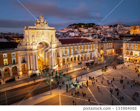 Experience the magic of Christmas in Lisbon as Praca do Comercio glows with festive lights in the evening twilight. Experience the magic of Christmas in Lisbon as Praca do Comercio glows with festive lights in the evening twilight. 133984088