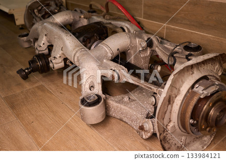 Vintage vehicle restoration, Old car parts under warm workshop lighting, Scene depicting classic vehicle undergoing restoration with rusted parts and scattered tools Vintage vehicle restoration, Old car parts under warm workshop lighting, Scene depicting classic vehicle undergoing restoration with rusted parts and scattered tools 133984121