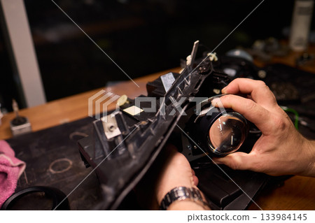 Careful precision is essential when installing a car headlight assembly for optimal performance Careful precision is essential when installing a car headlight assembly for optimal performance 133984145