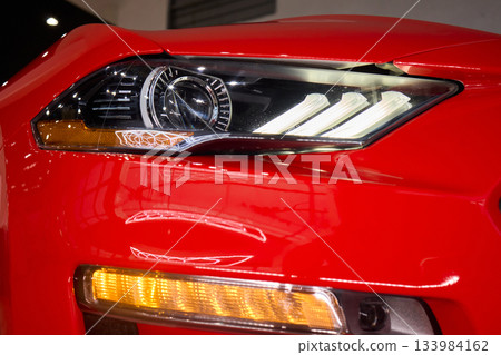 Close up of a cars headlight, part of automotive design 133984162