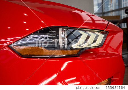 Close up of a cars headlight, part of automotive design Close up of a cars headlight, part of automotive design 133984164