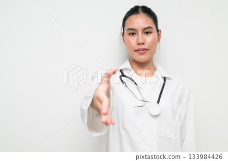 Woman Doctor with Stethoscope in White Uniform on Plain Background Greeting with Handshake Woman Doctor with Stethoscope in White Uniform on Plain Background Greeting with Handshake 133984426