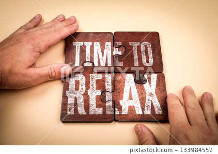 Time to Relax Wooden Puzzle Pieces Assembled on Beige Surface 133984552