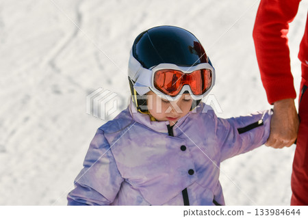 Ski coach giving a lesson to a child Ski coach giving a lesson to a child 133984644