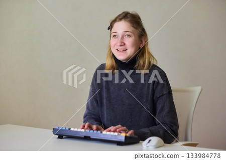 Determined individual with cerebral palsy immersed in educational activities indoors, Courageous woman with cerebral palsy concentrates on studying at home with dedication 133984778