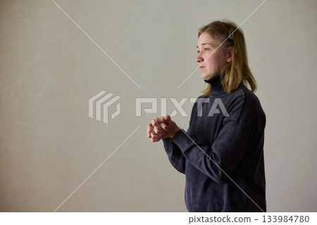 Woman exercises indoors, Individual with cerebral palsy performing warmup, Serene young woman with mobility challenges practicing controlled physiotherapy routines indoors 133984780