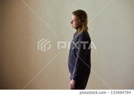 Woman exercises indoors, Individual with cerebral palsy performing warmup, Serene young woman with mobility challenges practicing controlled physiotherapy routines indoors Woman exercises indoors, Individual with cerebral palsy performing warmup, Serene young woman with mobility challenges practicing controlled physiotherapy routines indoors 133984784