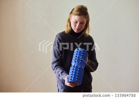 Woman exercises indoors, Individual with cerebral palsy performing warmup, Serene young woman with mobility challenges practicing controlled physiotherapy routines indoors 133984788