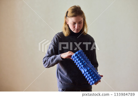 Woman exercises indoors, Individual with cerebral palsy performing warmup, Serene young woman with mobility challenges practicing controlled physiotherapy routines indoors Woman exercises indoors, Individual with cerebral palsy performing warmup, Serene young woman with mobility challenges practicing controlled physiotherapy routines indoors 133984789