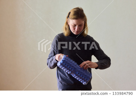 Woman exercises indoors, Individual with cerebral palsy performing warmup, Serene young woman with mobility challenges practicing controlled physiotherapy routines indoors 133984790