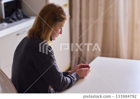 Self reliant woman handles morning pills in peaceful kitchen setting, Woman with cerebral palsy diligently manages her daily medication routine independently at home Self reliant woman handles morning pills in peaceful kitchen setting, Woman with cerebral palsy diligently manages her daily medication routine independently at home 133984792