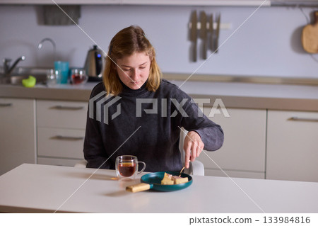 cerebral palsy Young woman smiling with tea and cheesecake, Casual domestic setting featuring woman indulging and relaxing, Relaxed young woman savoring cake and tea at sunlit kitchen table cerebral palsy Young woman smiling with tea and cheesecake, Casual domestic setting featuring woman indulging and relaxing, Relaxed young woman savoring cake and tea at sunlit kitchen table 133984816