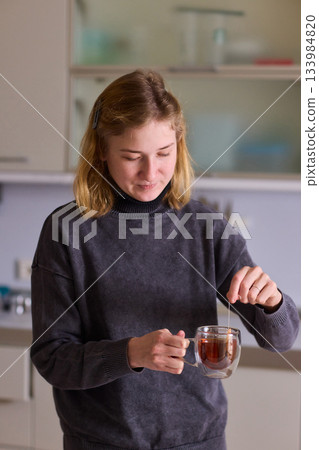 Cerebral palsy Morning tea moment, Relaxed individual enjoying peaceful routine with hot beverage, Tranquil domestic scene highlighting personal care during quiet morning moment 133984820