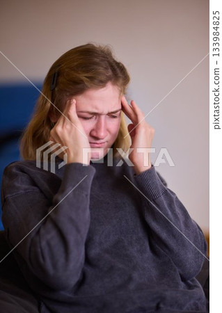 Woman in distress, Woman with cerebral palsy showing signs of emotional and physical exhaustion, Candid portrait of young woman expressing emotional pain and resilient endurance in cozy setting Woman in distress, Woman with cerebral palsy showing signs of emotional and physical exhaustion, Candid portrait of young woman expressing emotional pain and resilient endurance in cozy setting 133984825