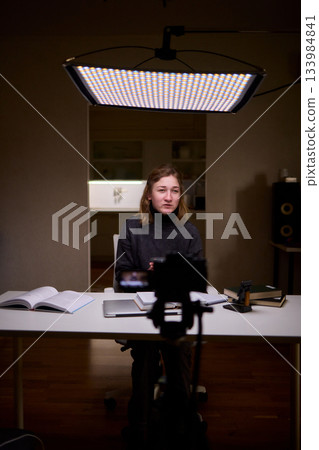 Young lady with cerebral palsy studying using technological aids, Enthusiastic woman with cerebral palsy learning with aid of modern assistive technology at bright workspace 133984841