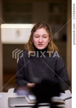 Young lady with cerebral palsy studying using technological aids, Enthusiastic woman with cerebral palsy learning with aid of modern assistive technology at bright workspace Young lady with cerebral palsy studying using technological aids, Enthusiastic woman with cerebral palsy learning with aid of modern assistive technology at bright workspace 133984844