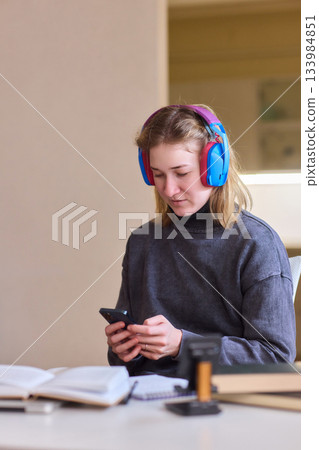 Young lady with cerebral palsy studying using technological aids, Enthusiastic woman with cerebral palsy learning with aid of modern assistive technology at bright workspace 133984851